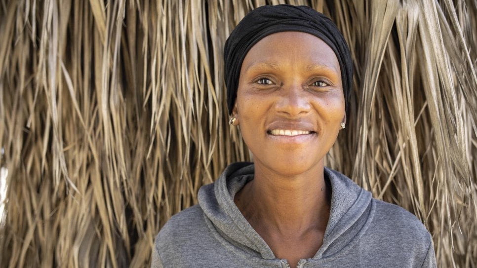 Regina, a South African beneficiary of food parcels distributed by the Somali business community, poses in Pretoria, South Africa.