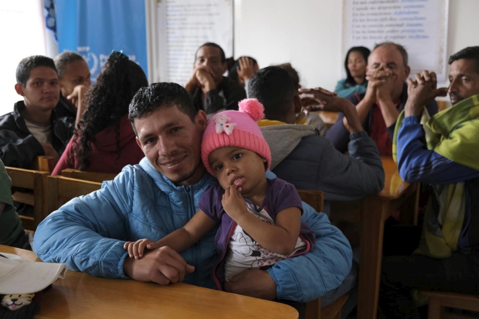 José Gregorio Ron, de 28 años, y su hija Greymal disfrutando del almuerzo que se les ofreció en el comedor comunitario Divino Niño en Tulcán, Ecuador.