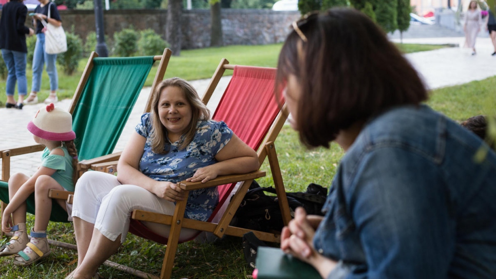 Kateryna Ryazantseva, who is with her daughter Anastasia, talks about her son, Dmytro, who has an intellectual disability,. They are at an event in Shevchenko Park, Kyiv, organised by Tetiana Baransova.