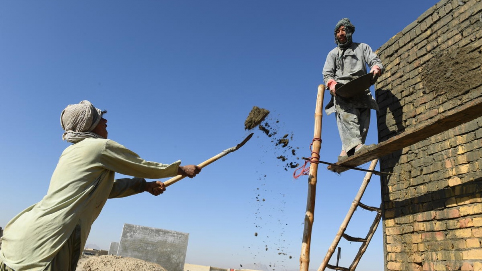 Afghan workers building a house in Kandahar province for one of the families benefiting from the Cash for Shelter project (3 February, 2020).

