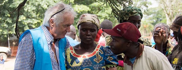 Uganda / Refugees / Hannin Mankell is interviewing a Congolese refugee woman in Rwamwanjia reception centre (Western Uganda). Nyirantezurundi Laurence, a single mother of two children whose husband was killed in DRC during the fighting.  She feared of being killed herself and so fled with her two children and other families in the village to Uganda.  This is her first time as a refugee and she has been at the centre for 1 month. Today she is leaving for the settlement.  When asked what she hoped life in Uganda would be like, she hoped, with gods will that her children would be safe. Her son Steven is 2 years, 9 months and her daughter, Jennifer is 5 years old. In Rwamwanjia refugees spend up to a week before being allocated plots of land to live on and cultivate. UNHCR has set up to communal shelters accommodating up to 250 people each and new arrivals are provided with hot meals by WFP (through Samaritans Purse). They are also provided with packages of essential items including jerry cans, mats, treated poles, hoes, saucepans, plastic sheeting, mosquito nets, slashers, pangas, soap and rope before being allocated land./ UNHCR / M. Sibiloni / November 2013