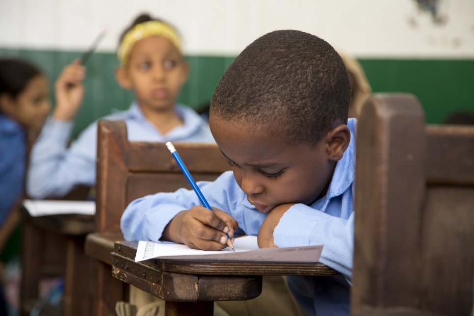 An African youngster studies hard during a children's education program at the St. Andrew's Refugee Services centre in Cairo in 2016, a partner program with UNHCR which provides financial assistance to refugee children in Egypt.