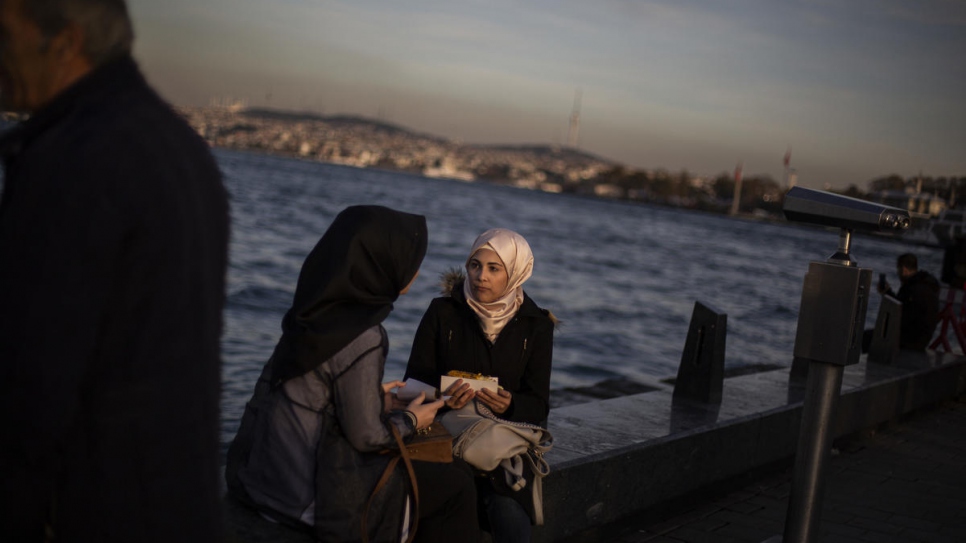 Sidra spends time with a friend on the historical Galata Bridge in Istanbul.