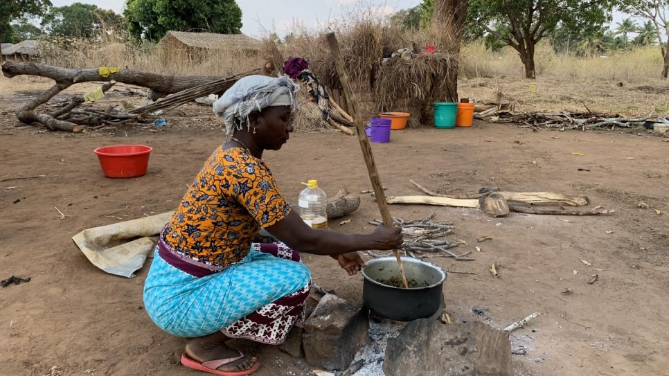 Joaquina* cooks for her family and relatives outside her brother's home in Montepuez after fleeing violent attacks in northern Mozambique.