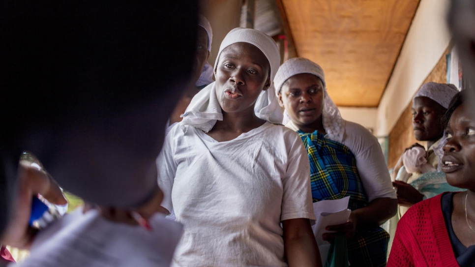 Emma (centre) waits to be registered at the District Commissioner's office near Nairobi.