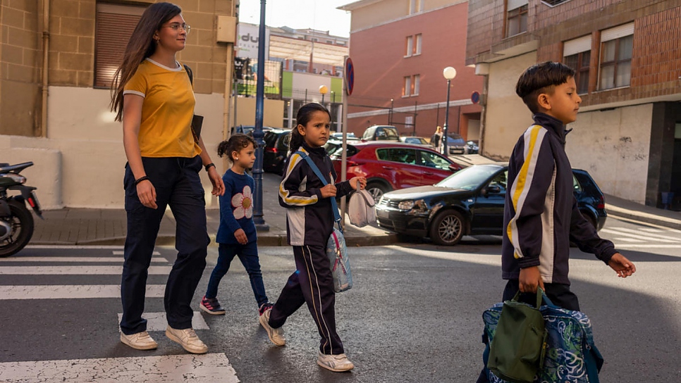 Volunteer Nagore picks up the children – from left, Meshael, 5, Sidra, 6, and Adnaan, 9 – from their school near Bilbao.