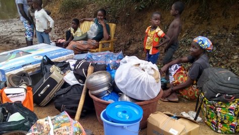 Asylum seekers fleeing political tension wait at the Buutuo border crossing in Liberia. 