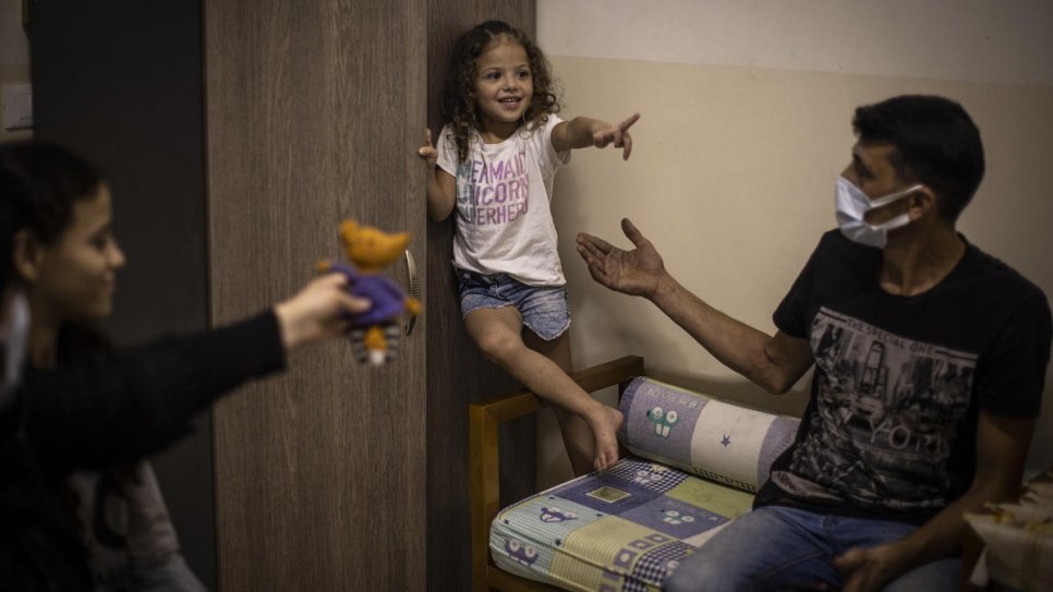 Manar plays with her father Mohammad at their home in Beirut, Lebanon.