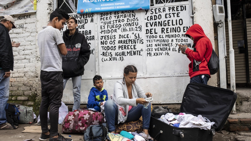 Venezuelan men get ready to continue their journey through the mountains after spending the night at Douglas Cabeza's shelter in Pamplona, next door to Marta Duque's home.