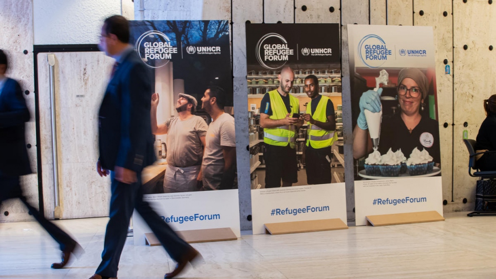 A display of posters in the Palais des Nations in Geneva ilustrates the Global Refugee Forum