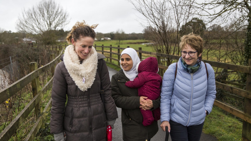 Ameh Arnout (centre), 23, walks with her friends Anna Roderick and Jackie Watson, in Ottery St Mary in Devon, south-west England. Anna and Jackie are members of the ABIDE community group, who worked to bring the Arnout family to the town under the UK's Community Sponsorship Programme.
