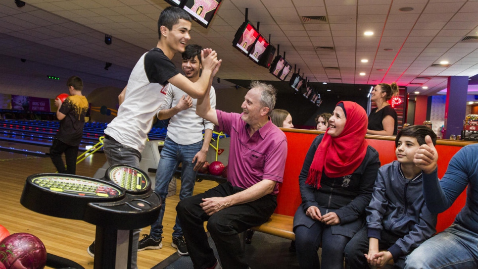 Sixteen-year-old Haitham Daour gives Ged Cavanagh a high five after a strike at a bowling alley in Bury, north-west England. Before the Daour family arrived in the UK they had never tried ten-pin bowling. Now they go once a month with Ged and other members of the community sponsorship group.
