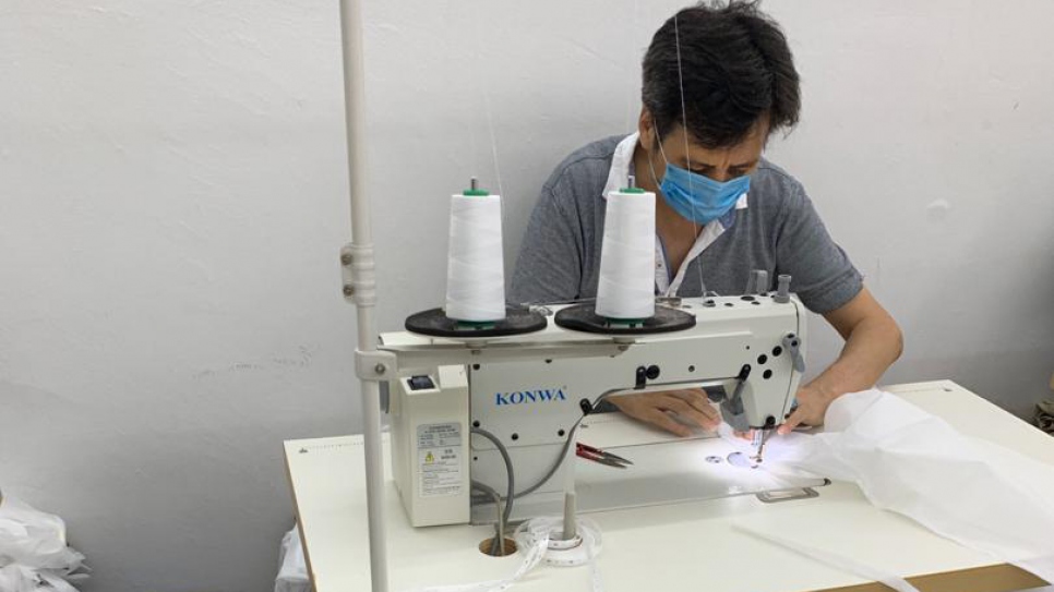 A refugee making personal protective equipment (PPE) at the Malaysian social enterprise, Earth Heir.  