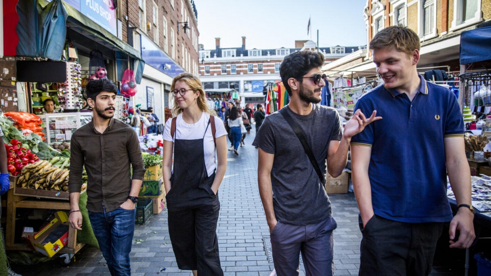 Syrian refugee brothers, Mohammed (wearing sunglasses) and Lutfi Al-Shaabin, visit Brixton Market in London, with Bea Forrester and Todd Baker of Peckham Sponsors Refugees. The local group, founded by Bea, are sponsoring the Al-Shaabin's resettlement in the UK.