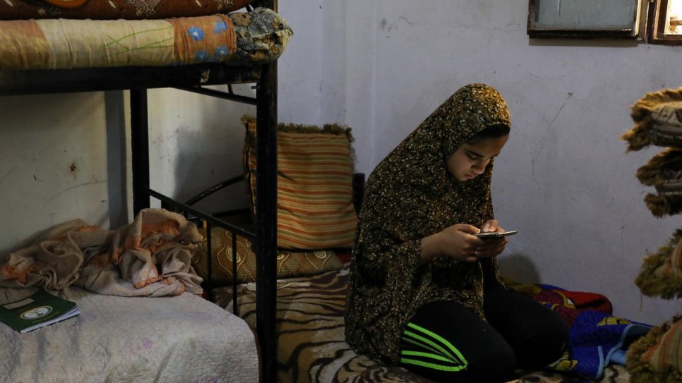 Fadia, 14, attempts to do an online test as part of her e-learning at home in Amman, Jordan. 