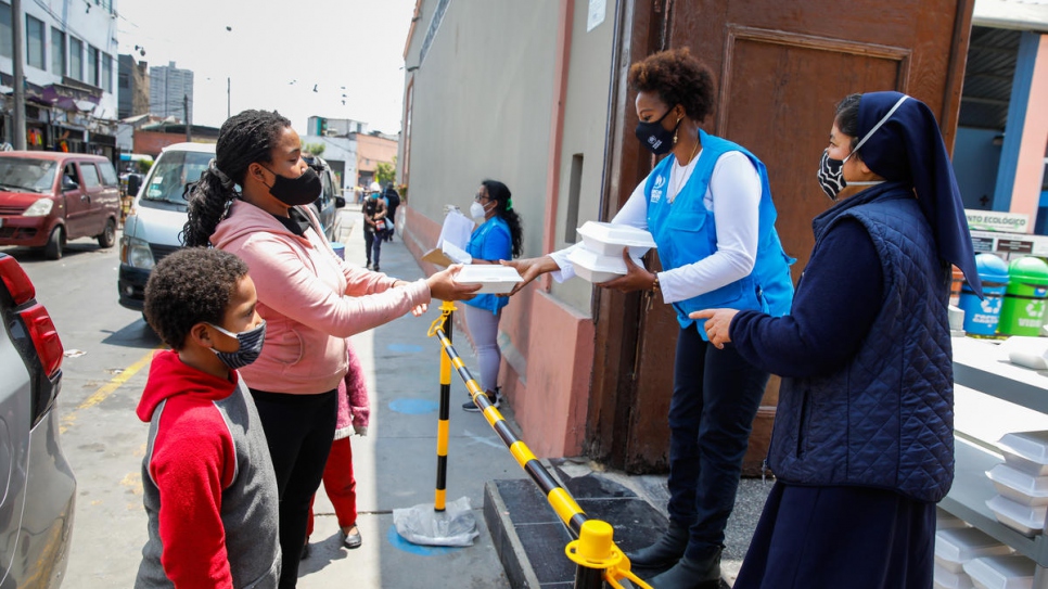 UNHCR's Juliette Murekeyisoni with Venezuelan volunteers at the Virgen de Lourdes Sanctuary in Lima. The organization delivers hundreds of lunches every day to Venezuelans and others in need. 