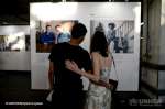 Des visiteurs regardent un portrait de l'exposition 'No Stranger Place' à Ground Control à Paris le 20 juin. Cette série de portraits, développée avec l'auteure Clémentine Baron en France, capture les liens d'amitié tissés entre des invités réfugiés et des hôtes européens. En partenariat avec le HCR, l'organisation a permis d'identifier les familles.