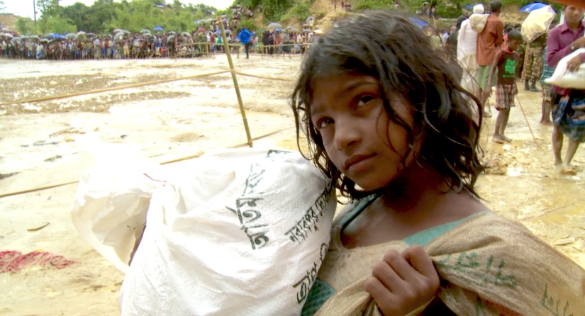 Rohingya girl carries donated aid