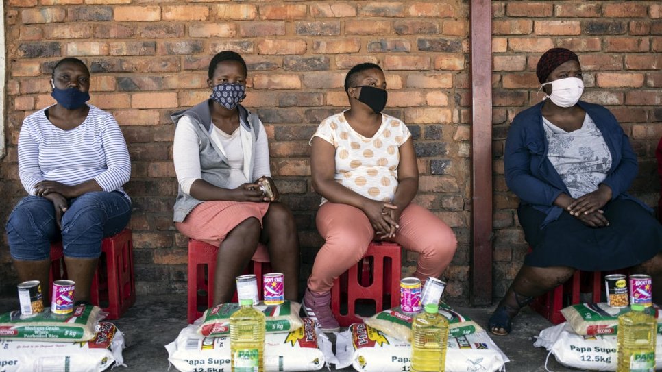 Vulnerable South African women receive food parcels including flour, rice, beans and oil from members of the Somali business community in Pretoria, South Africa.