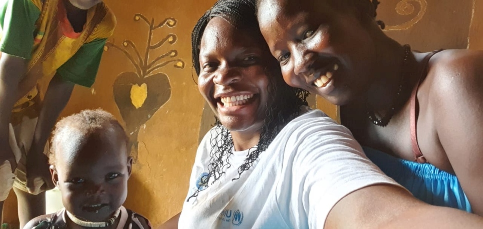 Millicent takes a selfie with a South Sudanese refugee mother and her child in Gambella, Ethiopia.