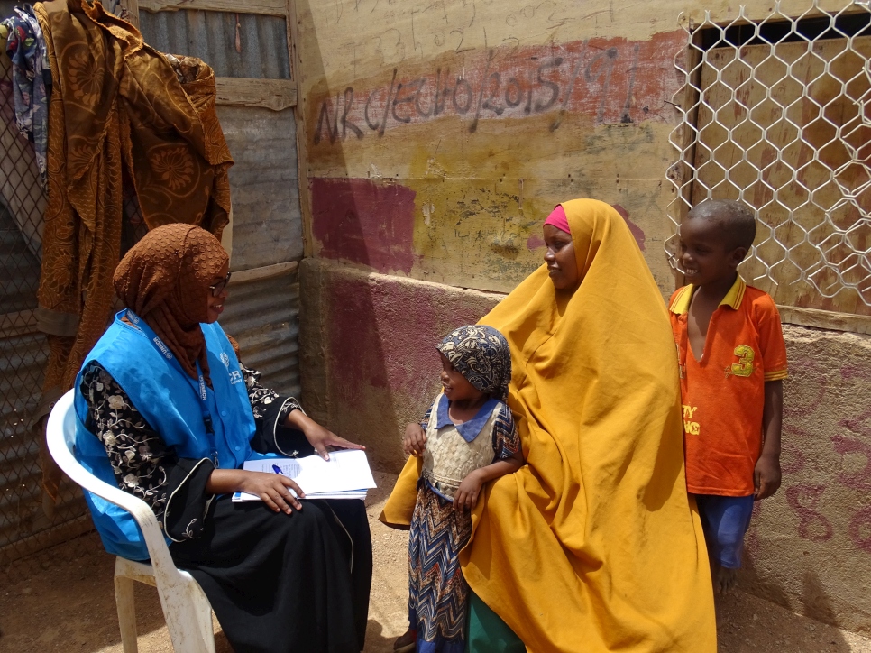 Bisharo (left) visits a family in Galkacyo, Somalia where she works as a Protection Associate.