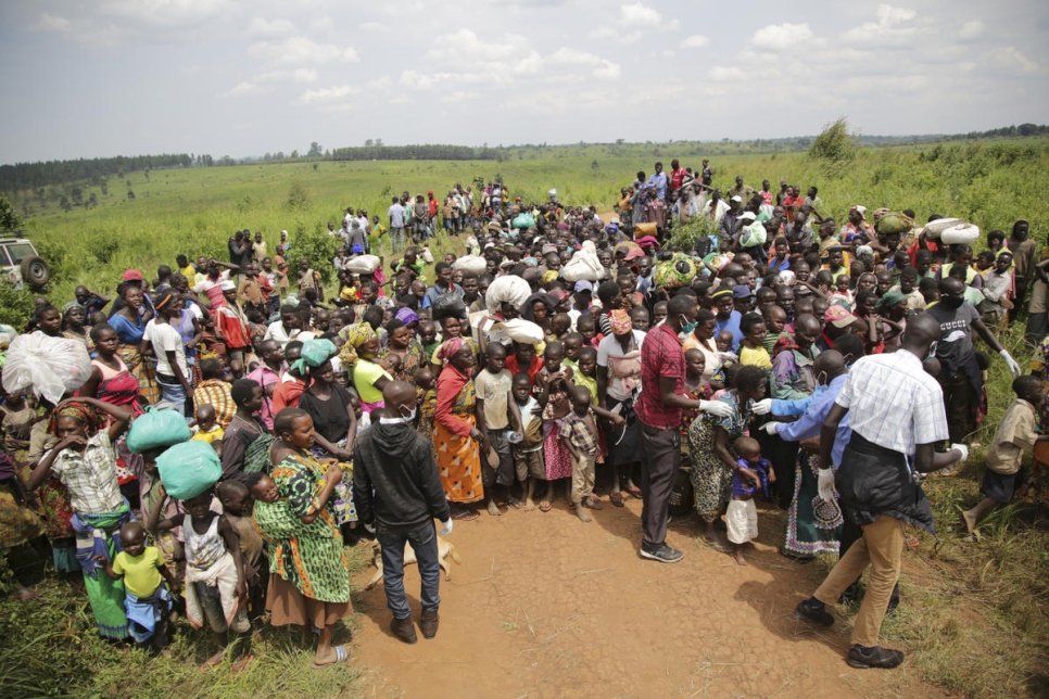 Des demandeurs d'asile de la République démocratique du Congo sont en attente de se soumettre à un contrôle sanitaire à la frontière à Zombo, en Ouganda. 