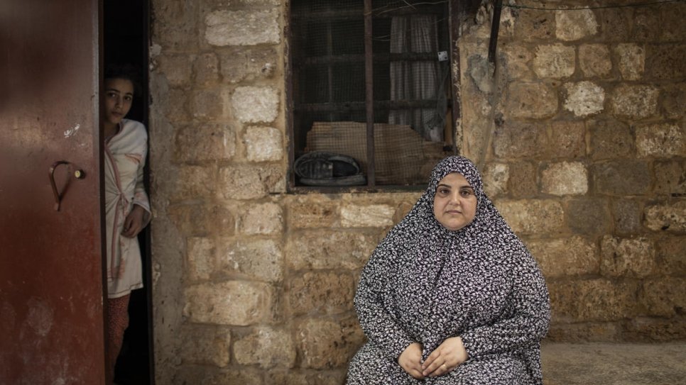 Syrian refugee, Bodour al-Qader, fled Homs in 2012, married a divorced Syrian and is stepmother to his four children, including 14-year-old Mahmdouha Rafik (left) in Tripoli, Lebanon. Before the economic crisis worsened, her husband worked a couple of days a week, but now they rely on humanitarian aid.