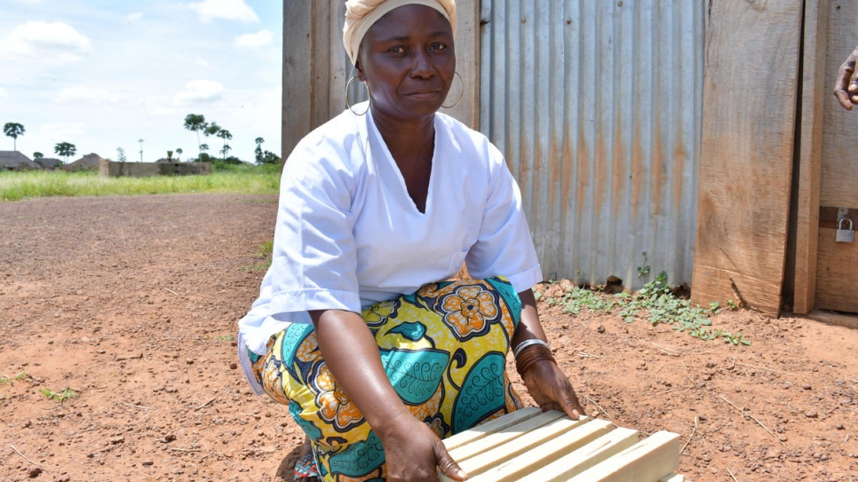 Albertine Marthe displays some bars of soap that she has made in Inke camp, the Democratic Republic of the Congo.