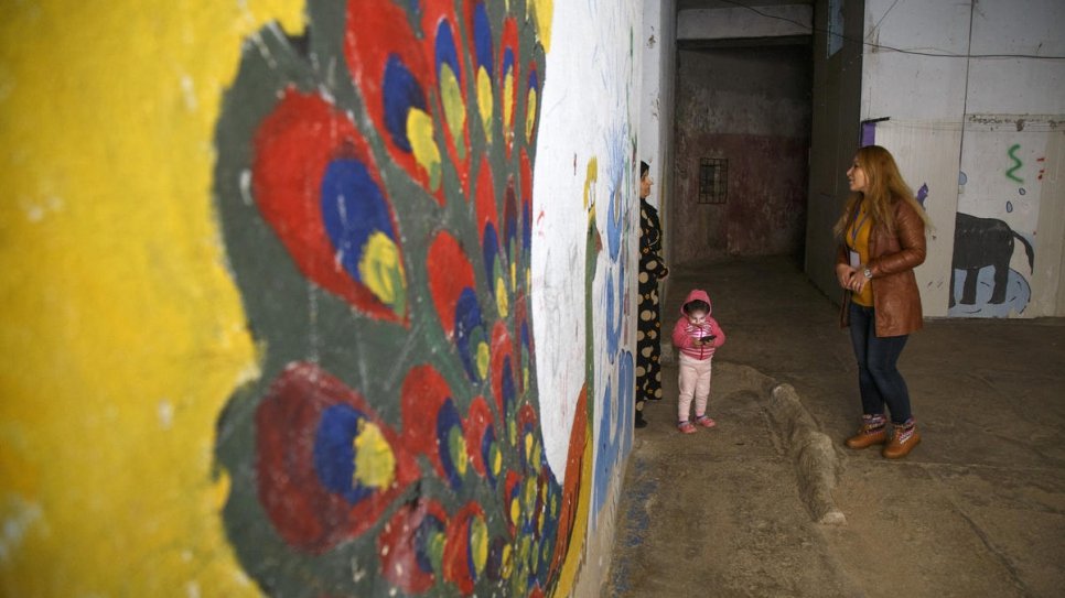 Community worker Falak Selo (right) talks to a fellow Syrian refugee about the mental health services available at Al-Qalaa (the Citadel) camp in Akre, northern Iraq (26 January, 2020).