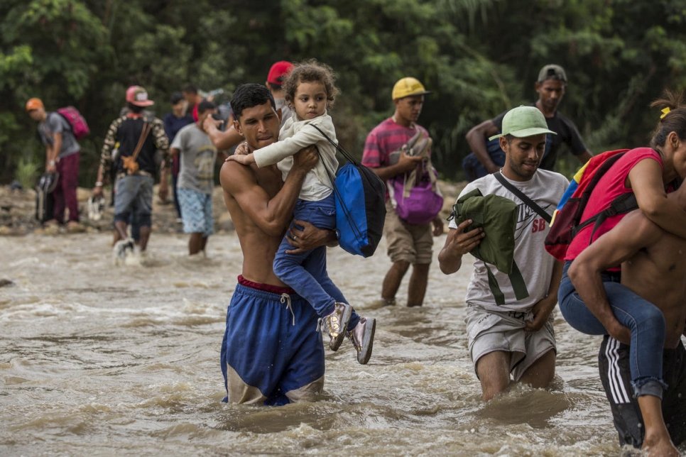 Venezuelans wade across the Tachira River to seek food and other aid in Cúcuta, Colombia.