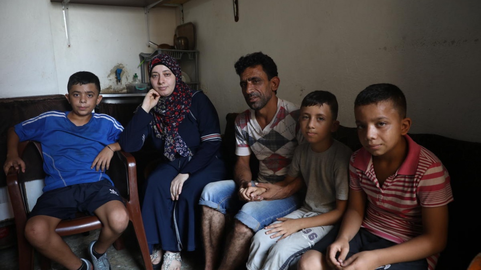 The family are pictured in their former apartment in the Jnah neighbourhood of the Lebanese capital.