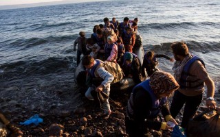 A group of Afghans recently arrive on the island of Lesbos after travelling in an inflatable raft from Turkey to Greece. More than 300,000 refugees and migrants have used the dangerous sea route across the Mediterranean so far this year.