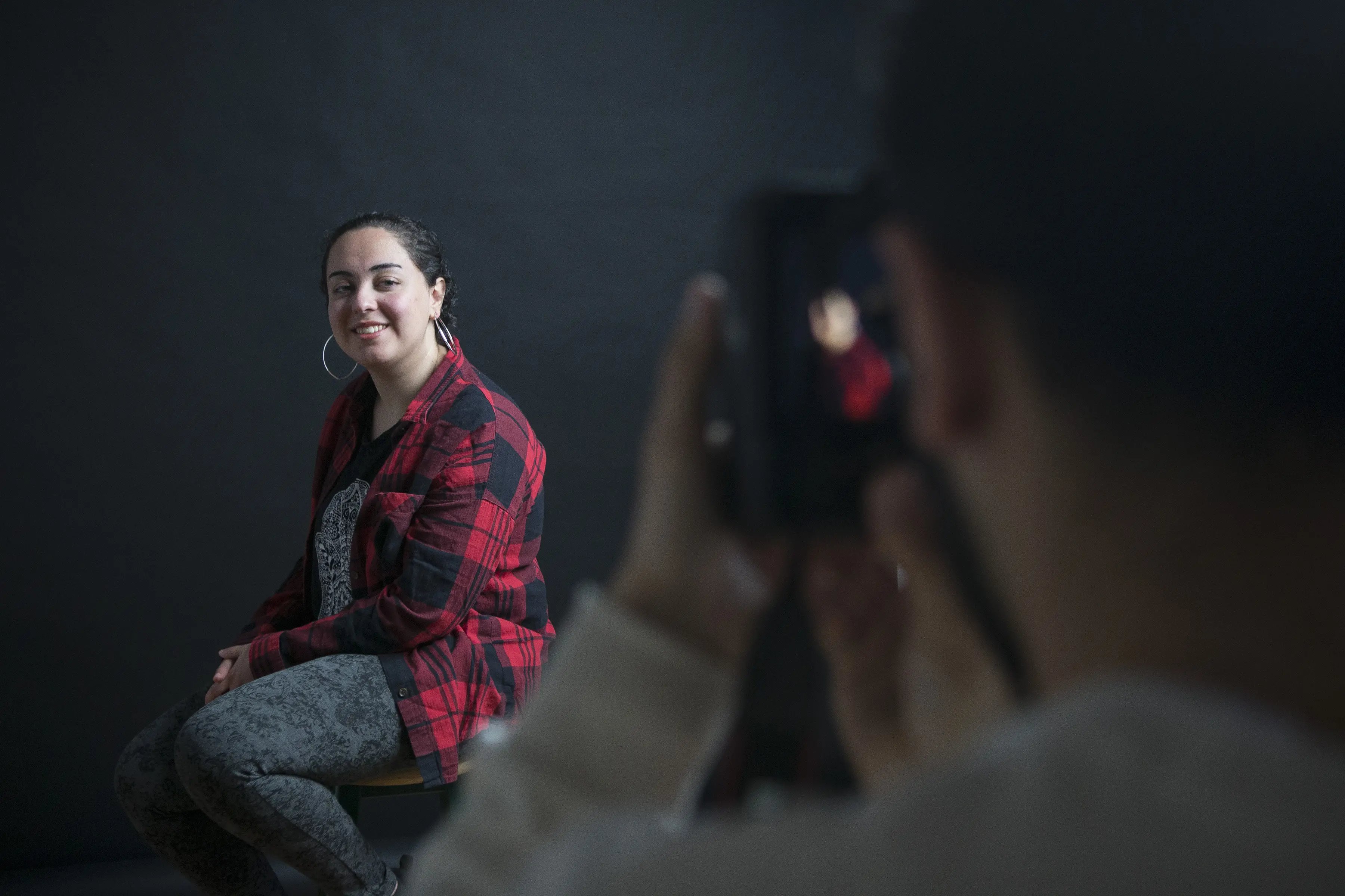 A photo of a photographer taking a portrait photo of a woman