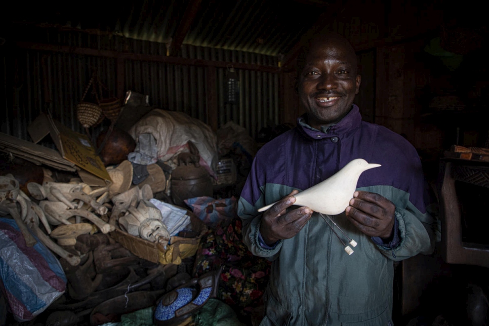 Artisan Kapya Kitungwa holds a wooden dove, a version of which he made for Made51 at his workshop in Nairobi, Kenya. He hopes his workshop will grow and employ many others. "It is my vision," he said. 
