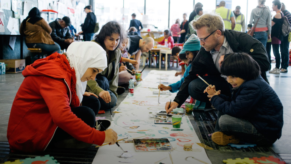 Volunteers paint with refugee children at the Hauptbahnhof train station in Vienna.