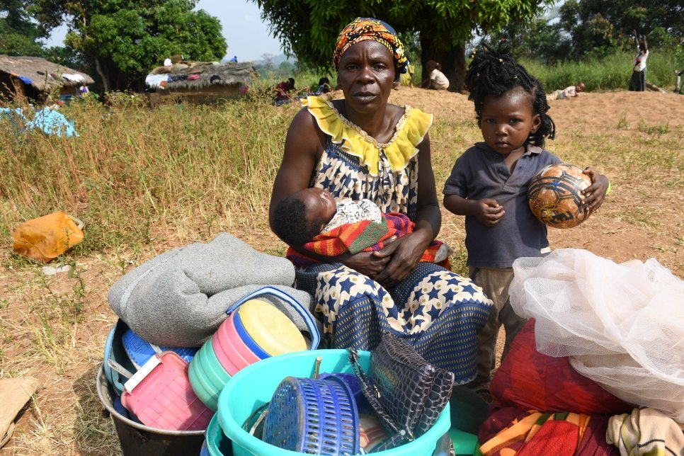 "We fled fearing that rebel groups would come and take over our town. We left everything behind and took a dugout canoe to cross the Ubangi river. We do not have food or a bed, but my daughter is constructing a shelter not far from here."

Yvette, 57, sits with two of her children in Ndu village in the Democratic Republic of the Congo (DRC) after fleeing Bangassou in the Central African Republic. It is the second time she has fled her country as a refugee – after escaping violence in 2017.