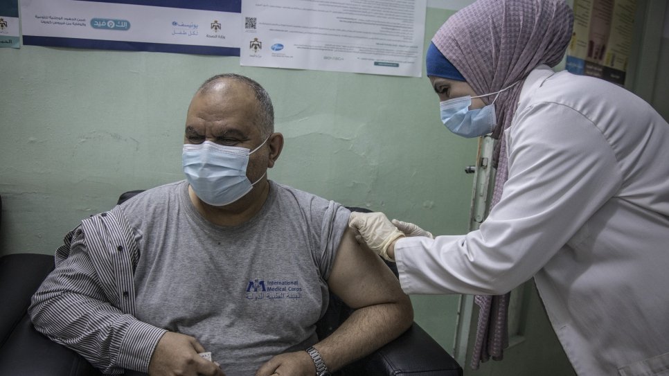 Iraqi refugee Ziad Al Kabashi receives a COVID-19 vaccine at a health centre in Irbid, Jordan.