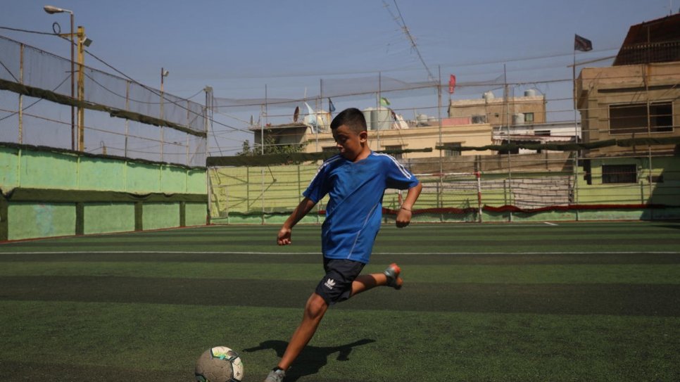 Syrian refugee Ghaith, 13, trains on the pitch at his local youth club in Beirut.