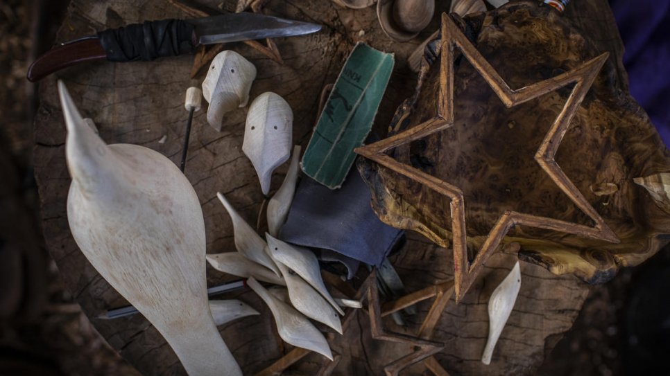 A collection of carvings and tools in the workshop of refugee and artisan Kapya Kitungwa.