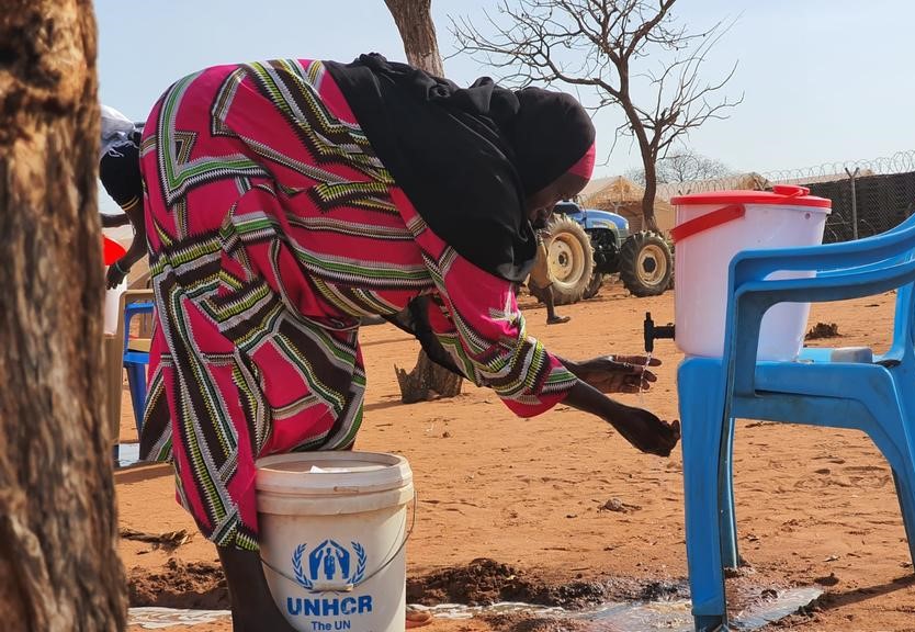 Sudanese refugees wash their hands before entering the general food distribution site at Pamir camp in Jamjang, north-east South Sudan.