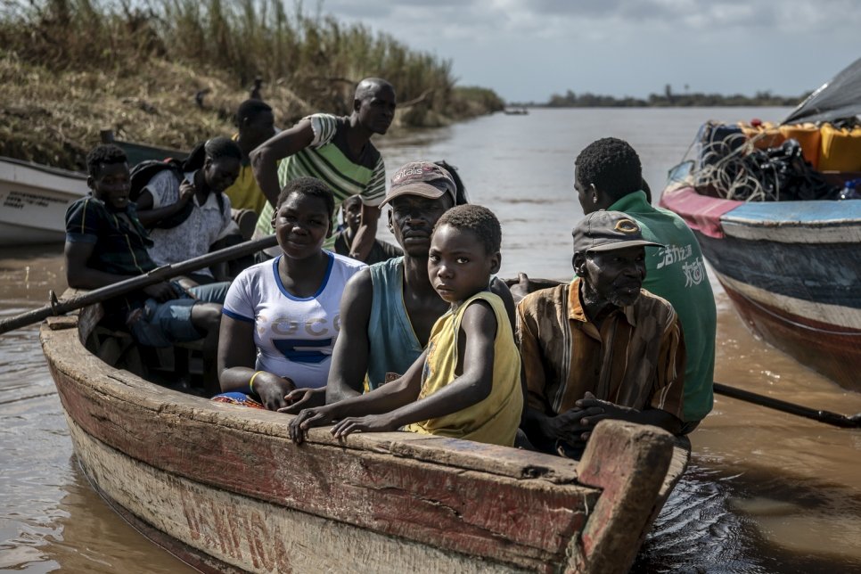 A small boat pulls into the  Buzi dock carrying residents. Many people displaced from Buzi in the aftermath of Cyclone Idai are returning to check on the status of their homes and belongings.