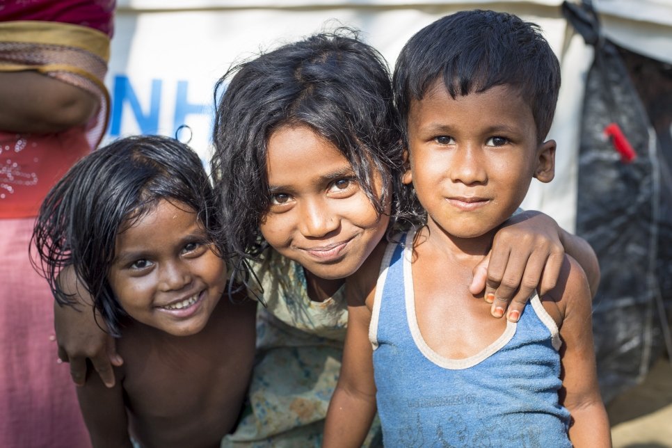 Portrait of Shumi 7, Abdullah Hamad 5, and Amina 5, at UNHCR transit centre