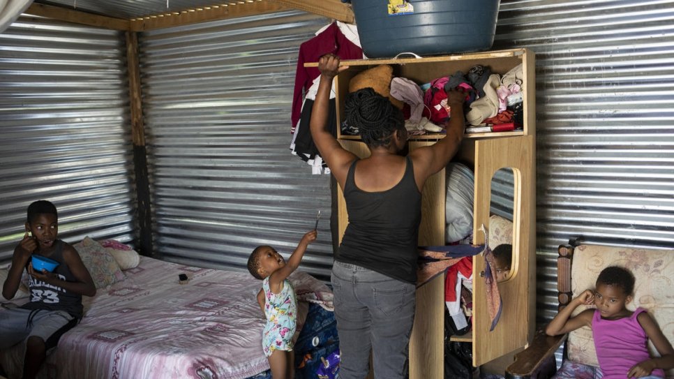 Mpho Modise tidies up the one room she shares with her four children in Brits, South Africa. She lacks identity papers as her birth was never registered.