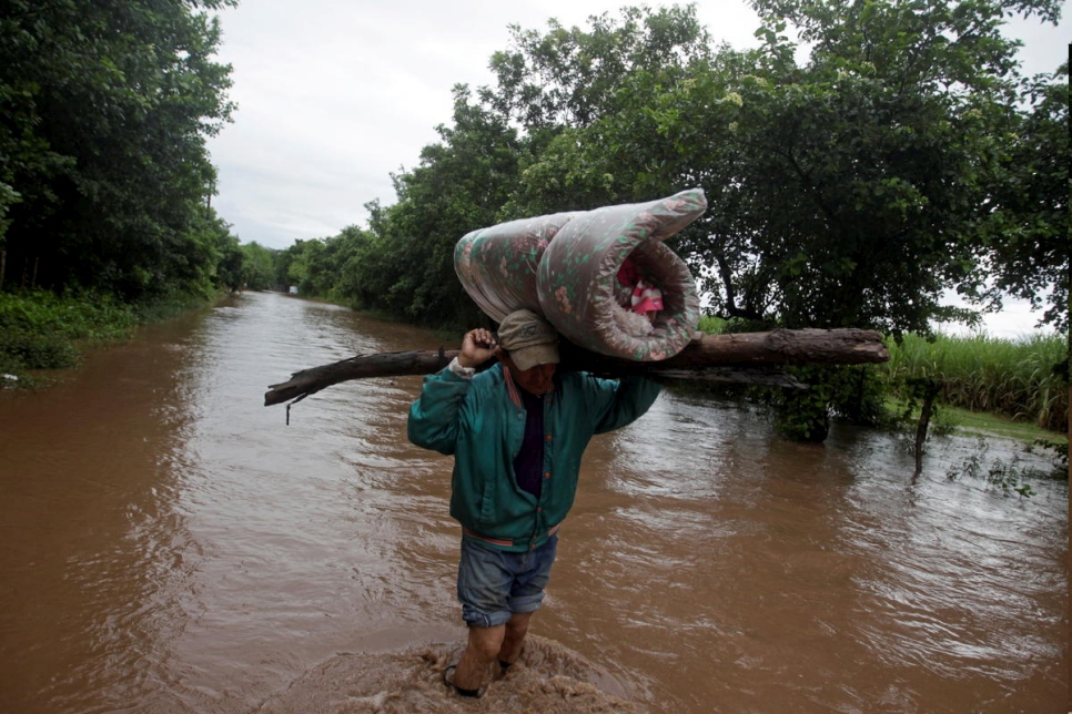Honduras. Man carries his belongings through a flooded road after the passing of Storm Iota, in Marcovia
