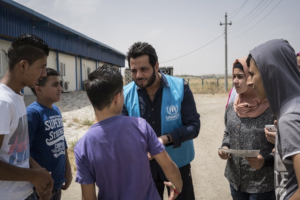 Lebanese TV host Neshan talks with finalists of Refugees Got Talent during a visit to Arbat refugee camp a day before the final.