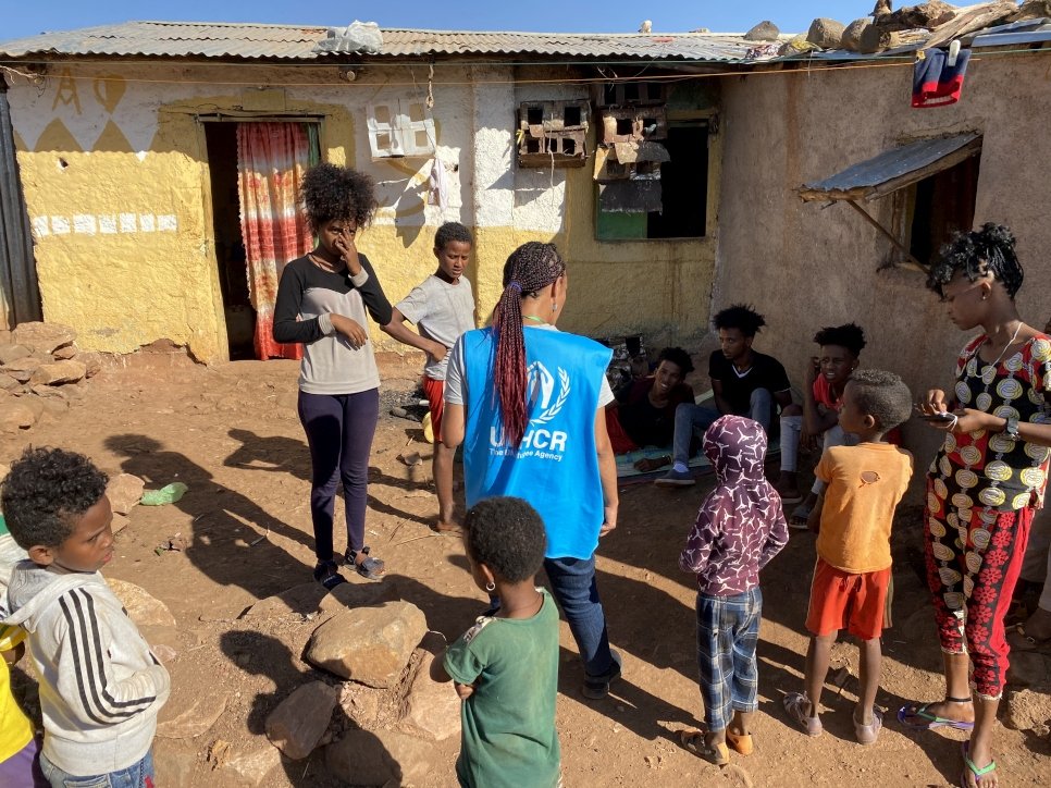 A UNHCR officer talks to refugees in Mai Aini refugee camp. The biggest concerns of the refugees are food, clean water, and the security situation in the camps. The refugees report almost nightly looting by armed gangs. 