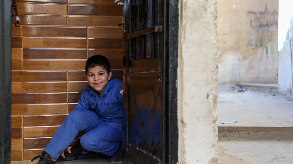 Le plus jeune fils de Djamila, Ahmed, 8 ans, dans l'entrée de leur appartement à Amman, en Jordanie. 