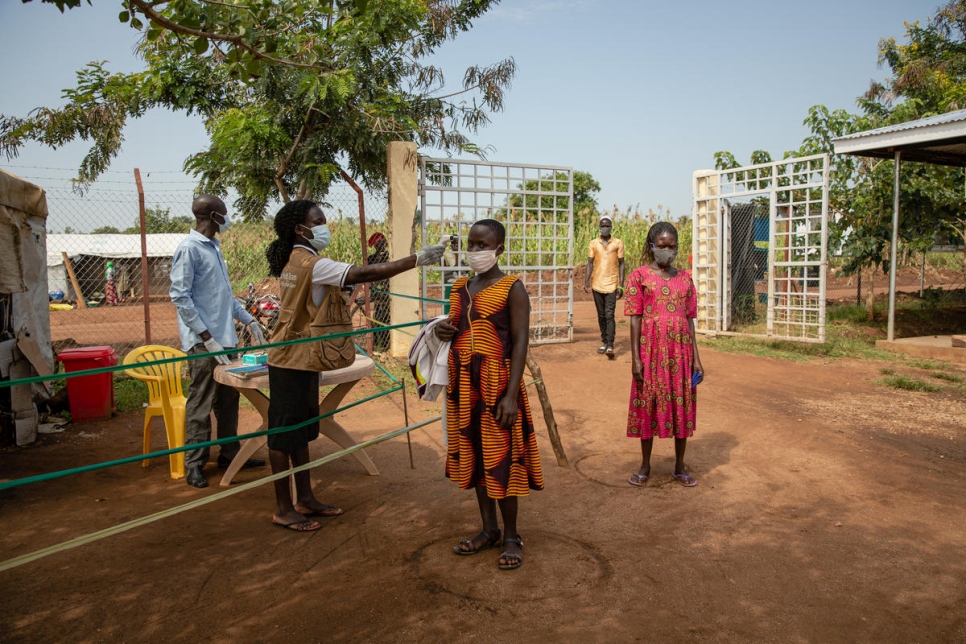 Une réfugiée sud-soudanaise passe un contrôle de température avant d'entrer dans un dispensaire de l'installation de réfugiés de Bidibidi en Ouganda. 