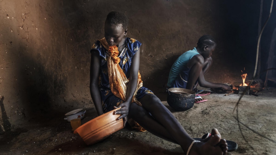 Des mineures non accompagnées du Soudan du Sud, Nyamach Lul (16 ans) et Nyakoang (13 ans), préparent le repas dans leur abri au camp de réfugiés de Jewi, en Éthiopie. 