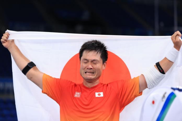 Japanese man celebrates holding flag